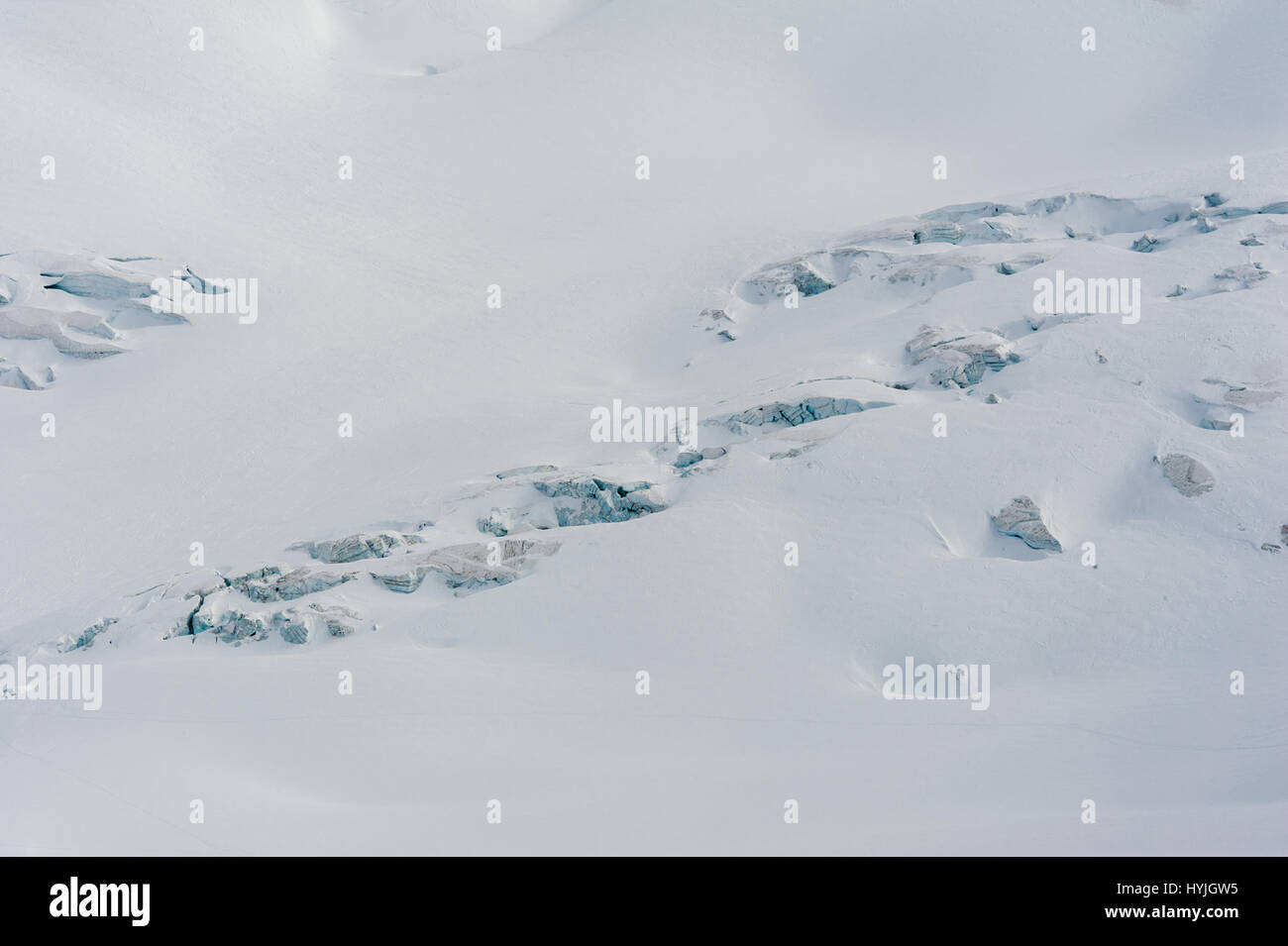 Glacier crevasses and seracs in a snow field in the high alpine Vallee Blanche in winter Stock Photo