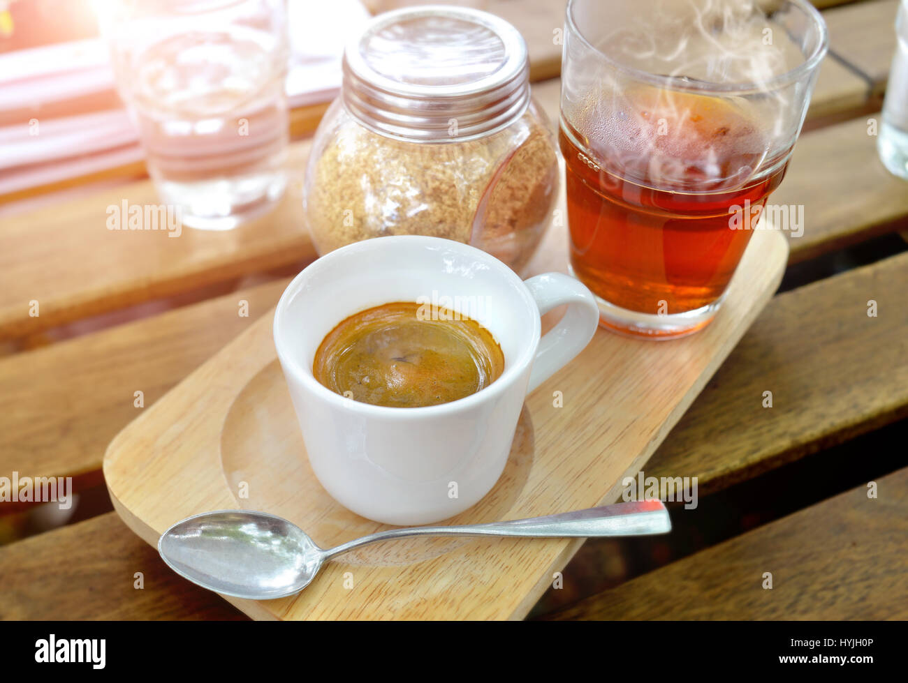 Espresso coffee shot in small cup serve with red tea and sugar in