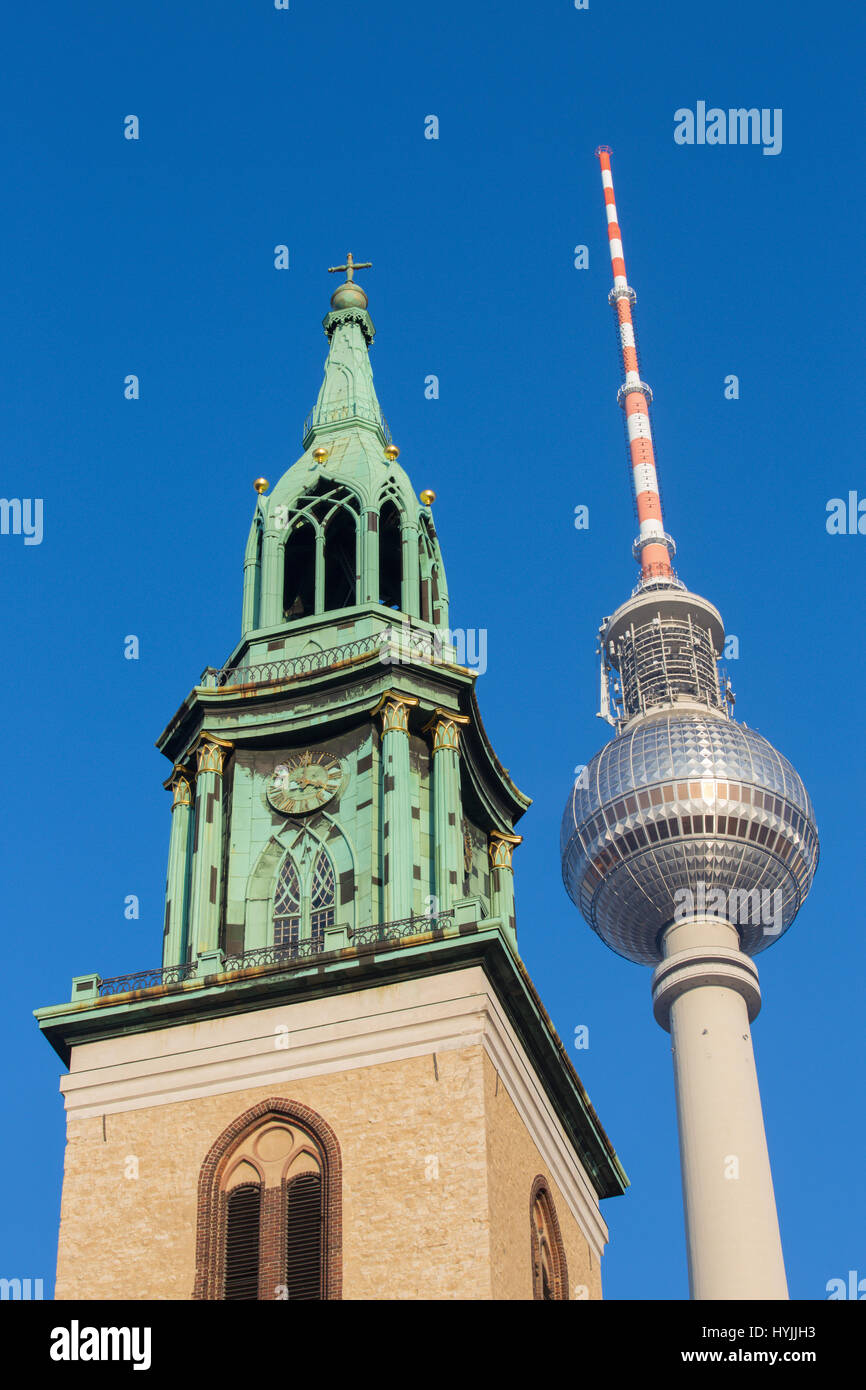 Berlin - The tower of Marienkirche church and the Fernsehturm. Stock Photo