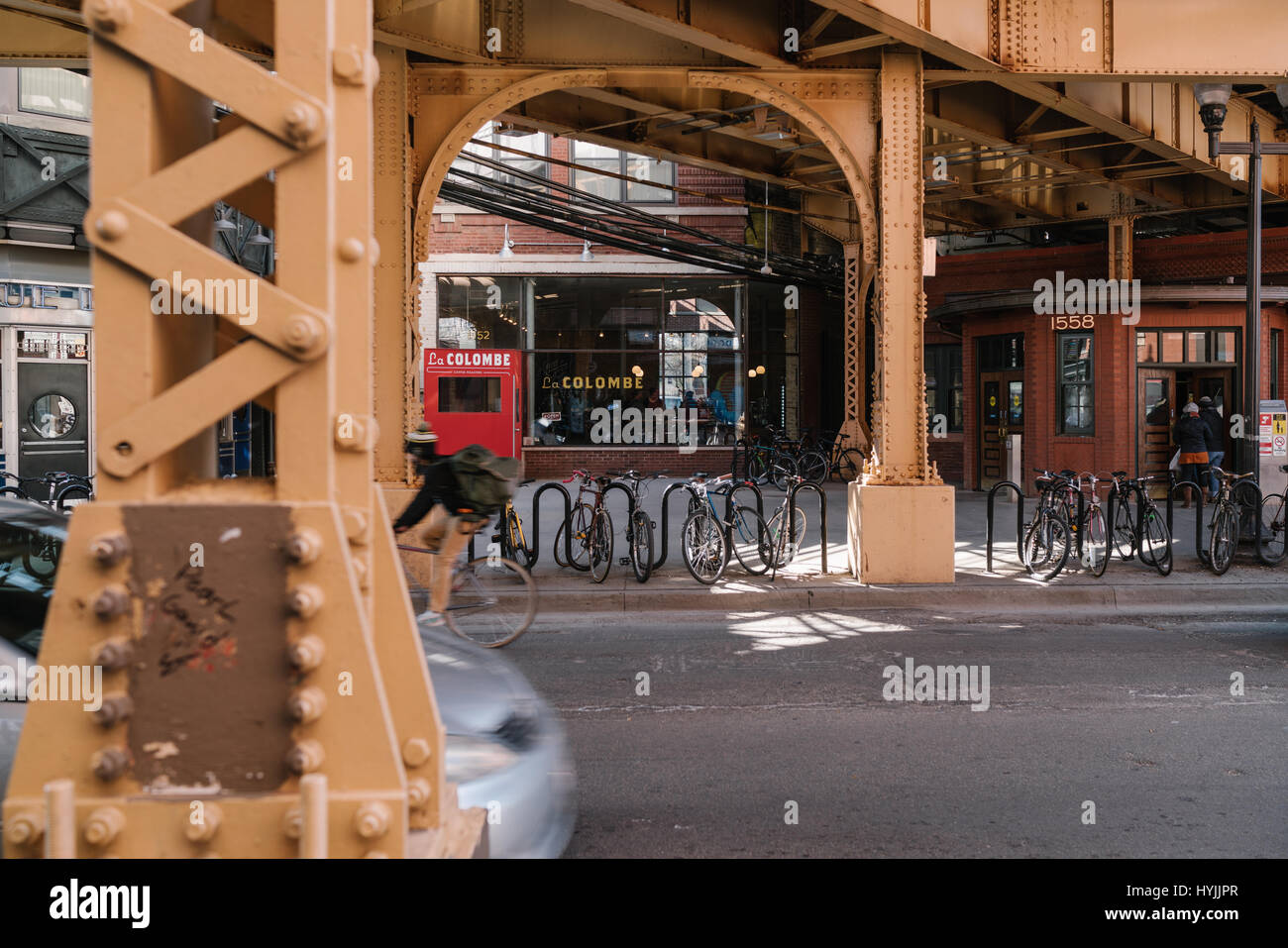 View of a cyclist under the Damen Station in Chicago Stock Photo