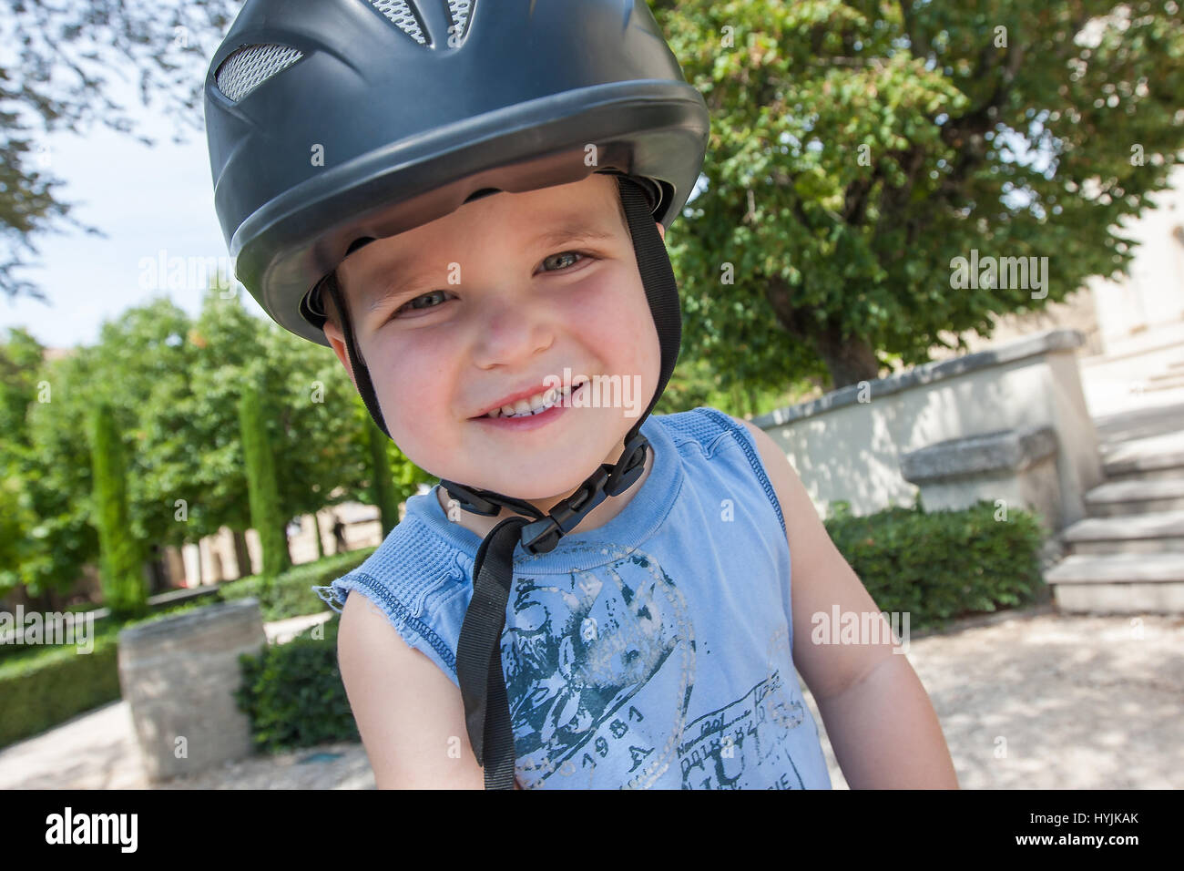 A boy wearing a horse riding helmet is smiling Stock Photo