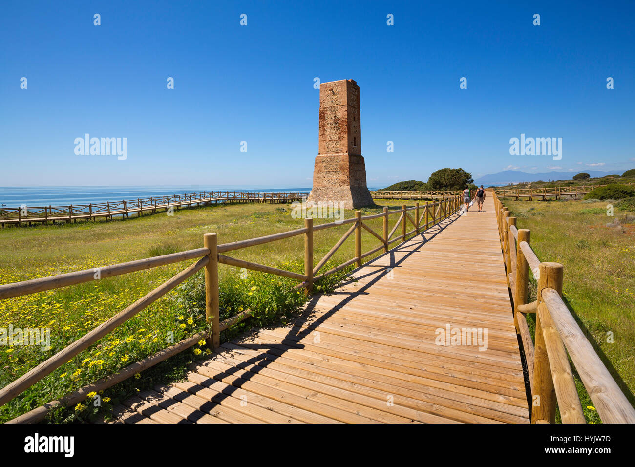 Los Ladrones moorish tower, wooden footpath, Natural Monument Dunas de Artola o Cabopino, Marbella. Malaga province Costa del Sol. Andalusia Southern  Stock Photo