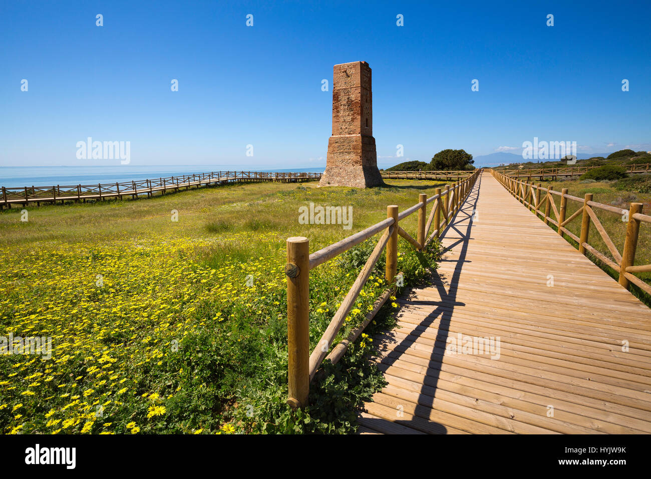 Los Ladrones moorish tower, wooden footpath, Natural Monument Dunas de Artola o Cabopino, Marbella. Malaga province Costa del Sol. Andalusia Southern  Stock Photo