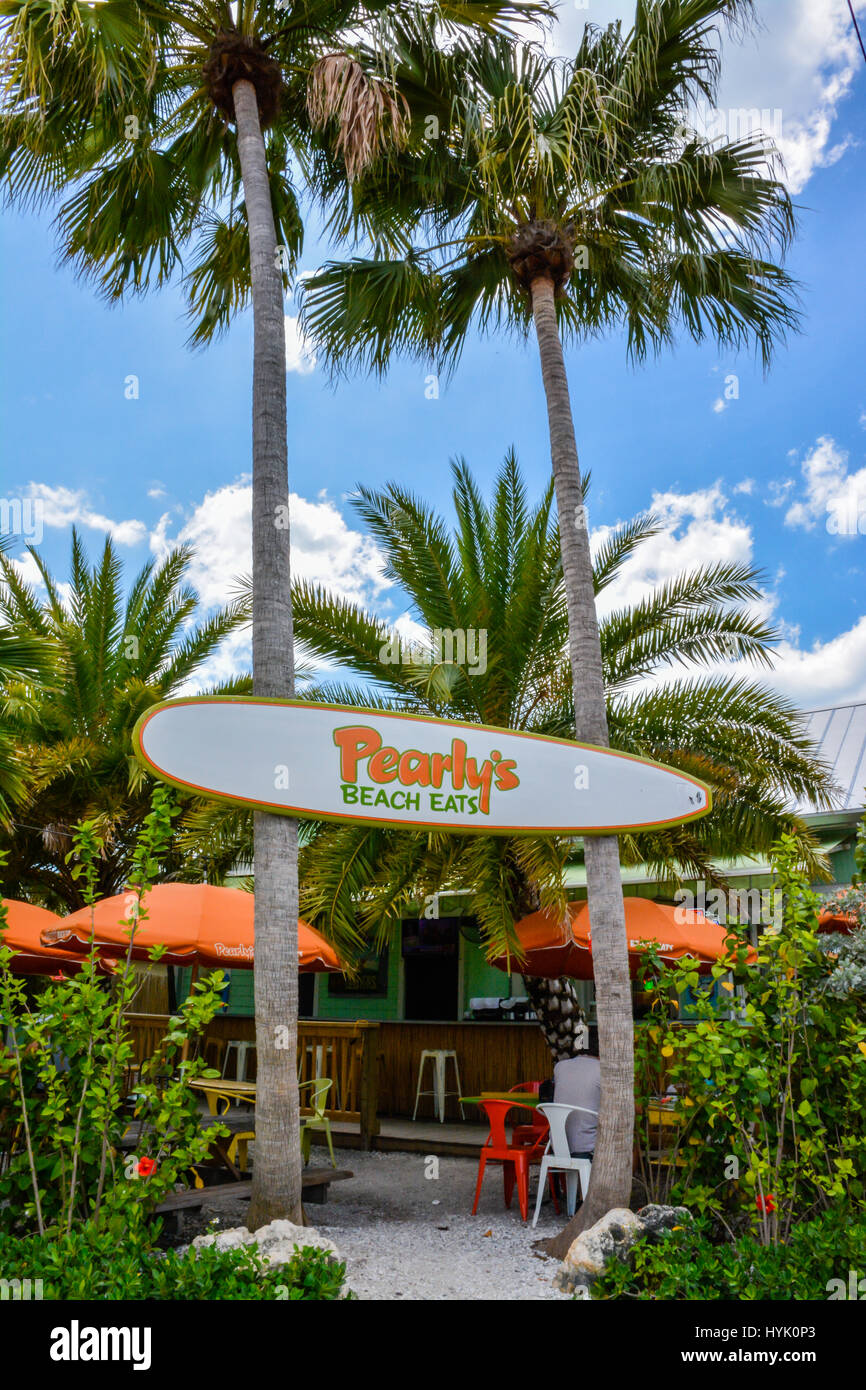 A surfboard sign welcomes guests to The tropical Entrance of Pearly's Beach Easts Restaurant, a popular, surf themed & funky seafood restaurant on Pap Stock Photo