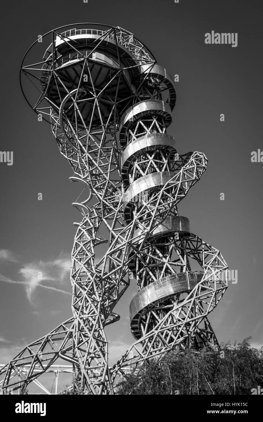 ArcelorMittal Orbit black and white tubular steel abstract  structure spiralling skyward with silver outer walkway and stainless steel steel slide cur Stock Photo