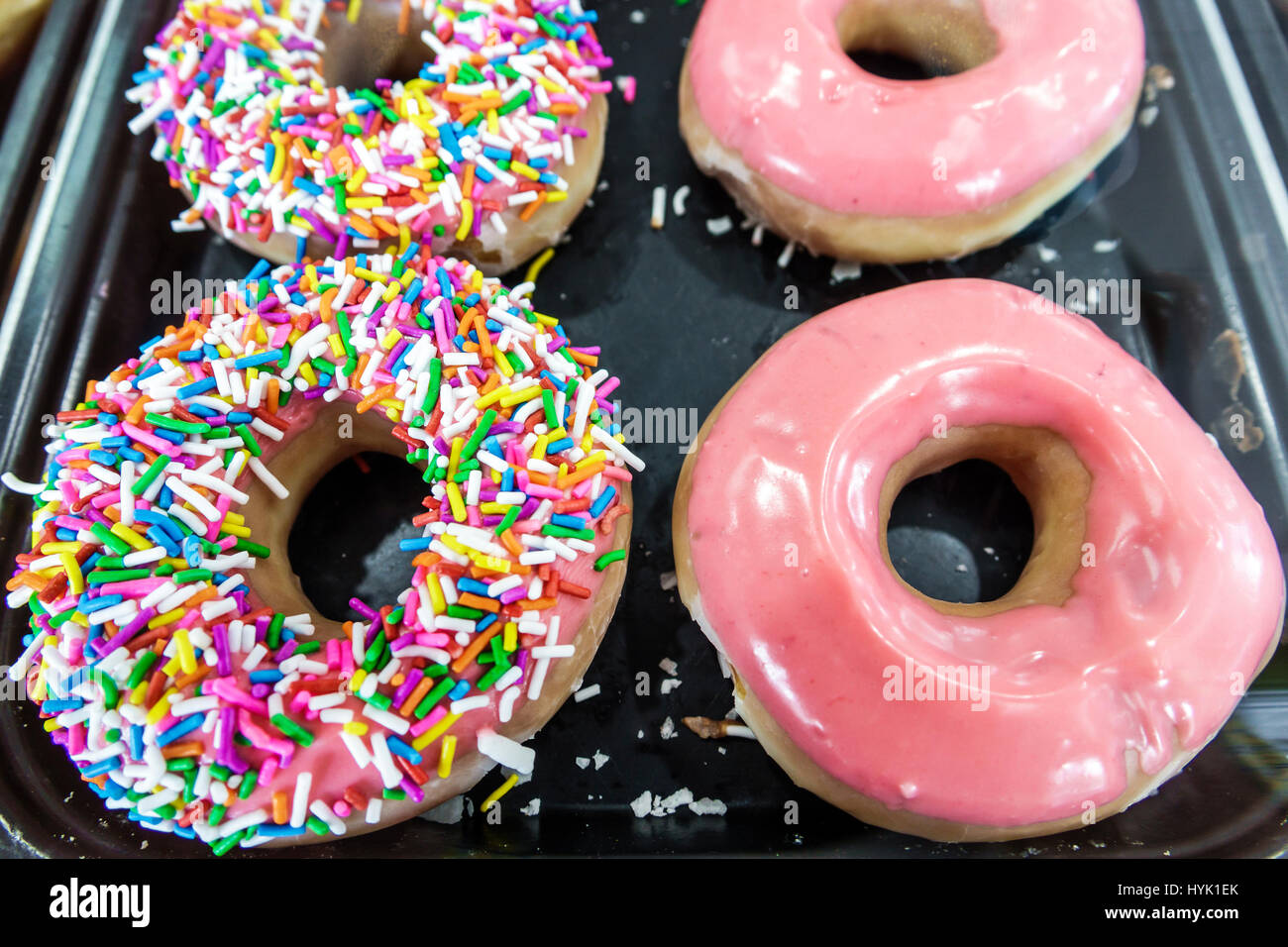 Orlando Winter Park Florida,Krispy Kreme Doughnuts,donut company,coffeehouse,sprinkles,pink glaze,donuts,icing,display sale FL170222145 Stock Photo