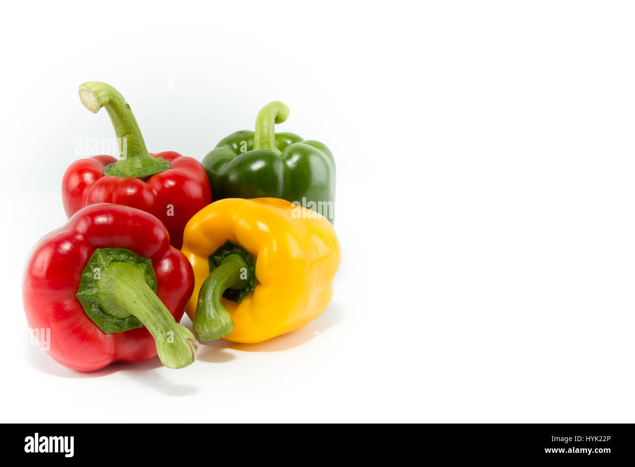 Different colors of fresh bell peppers isolated in white background