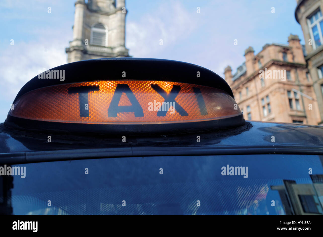 black London style taxi hire light on generic city view Stock Photo