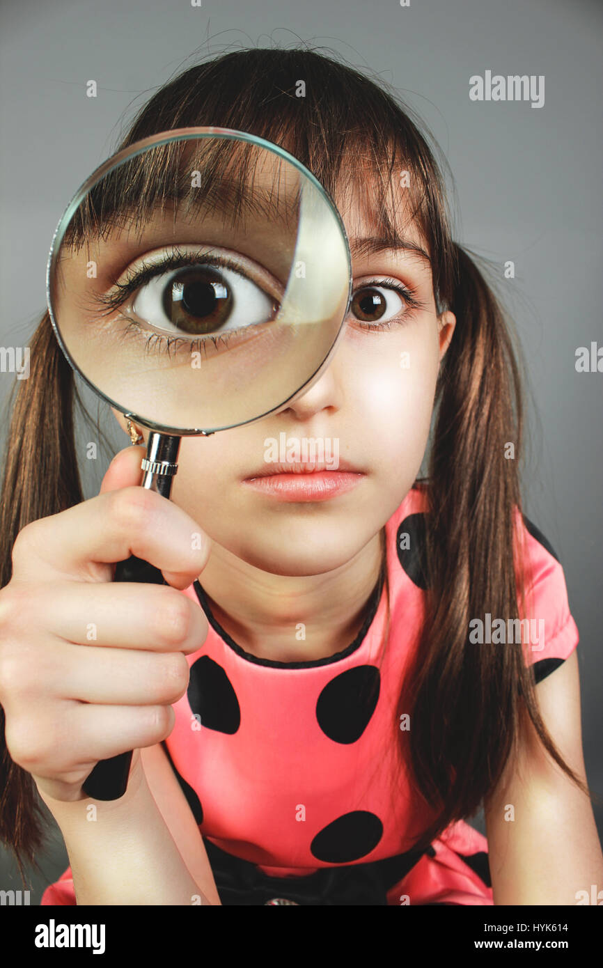 Little Child Girl Searching With Magnifying Glass Stock Photo