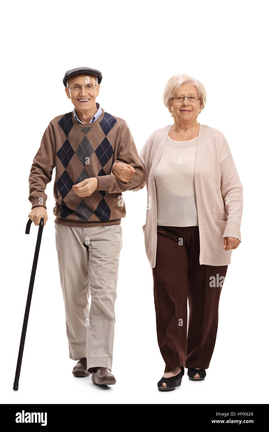 Full length portrait of an elderly man and woman walking towards the camera isolated on white background Stock Photo