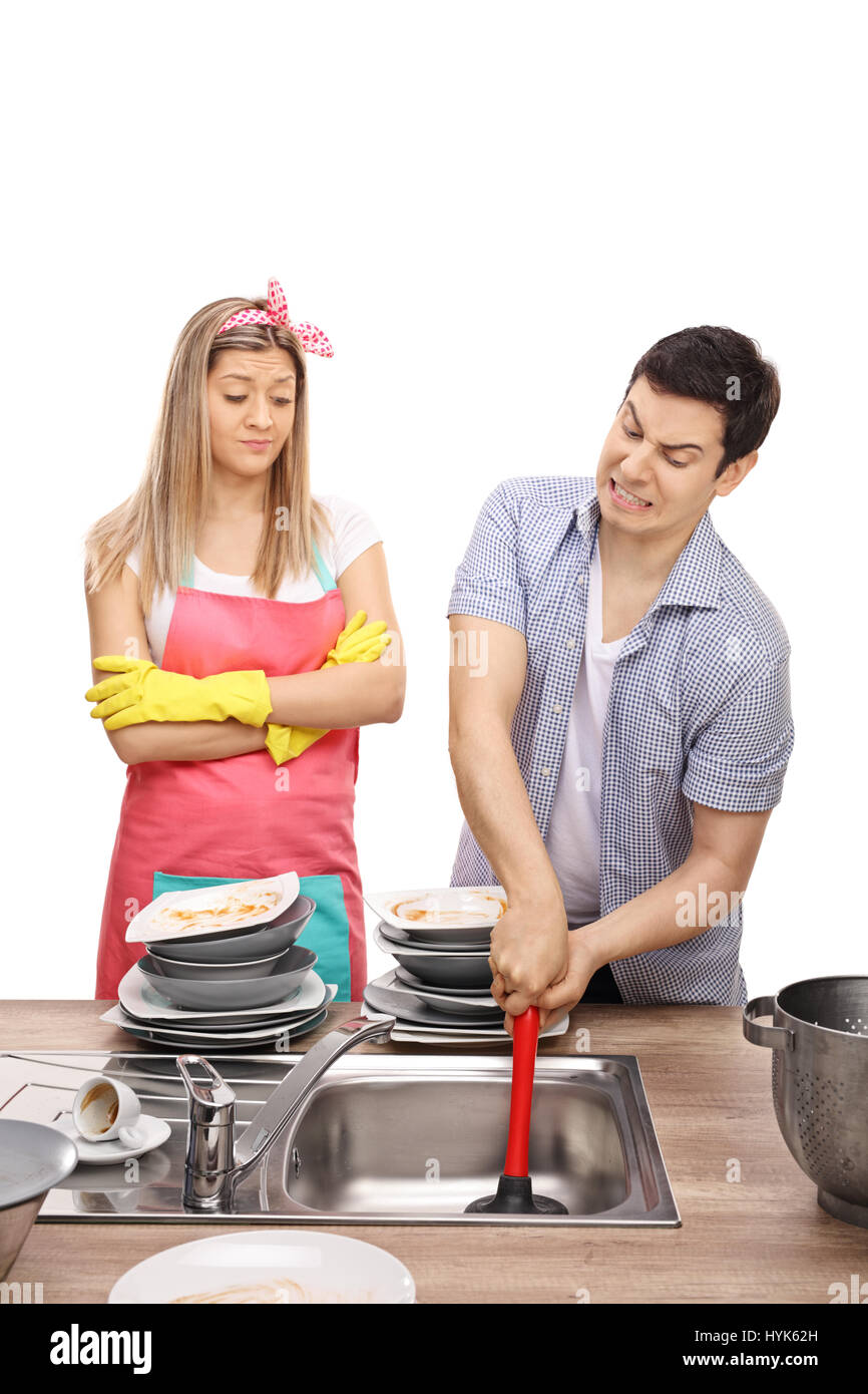Young woman looking at a young man trying to unclog a sink isolated on white background Stock Photo