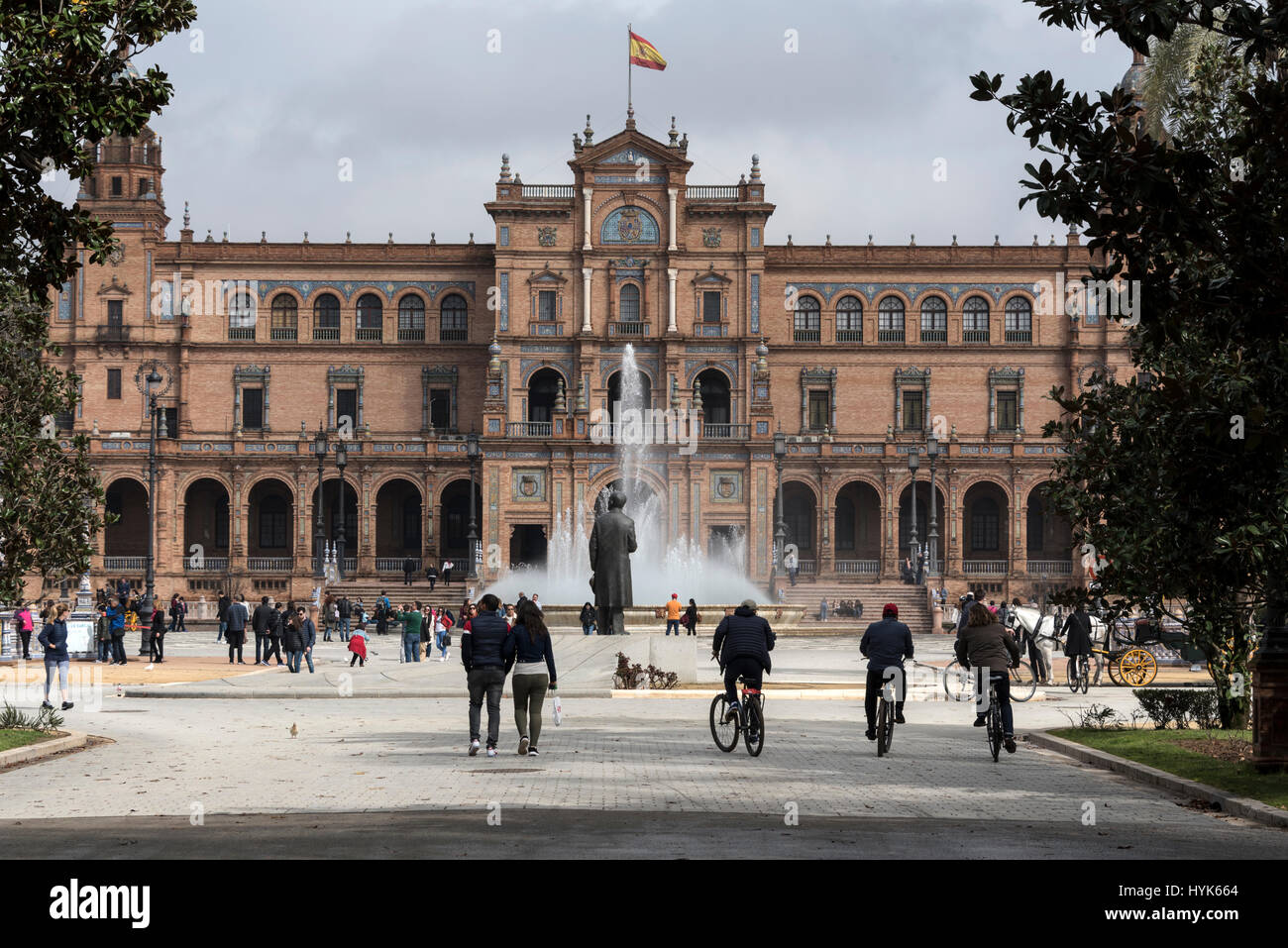 Tourists flock to the semi-circle frontage of the  Plaza de Espana, a popular venue in Seville, Spain.   The site is the biggest construction of the I Stock Photo