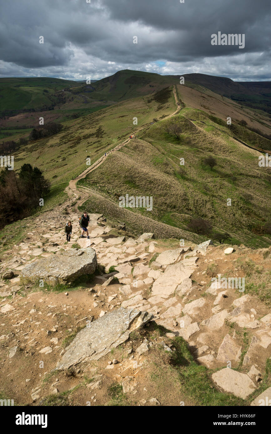 Walkers ascending the steep rocky path to Back Tor on the ridge walk from Mam Tor, Peak District, England. Stock Photo