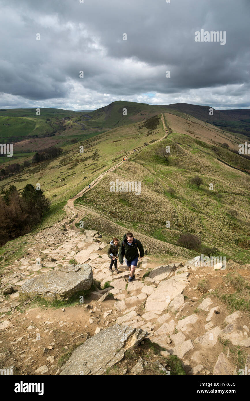 Walkers ascending the steep rocky path to Back Tor on the ridge walk from Mam Tor, Peak District, England. Stock Photo