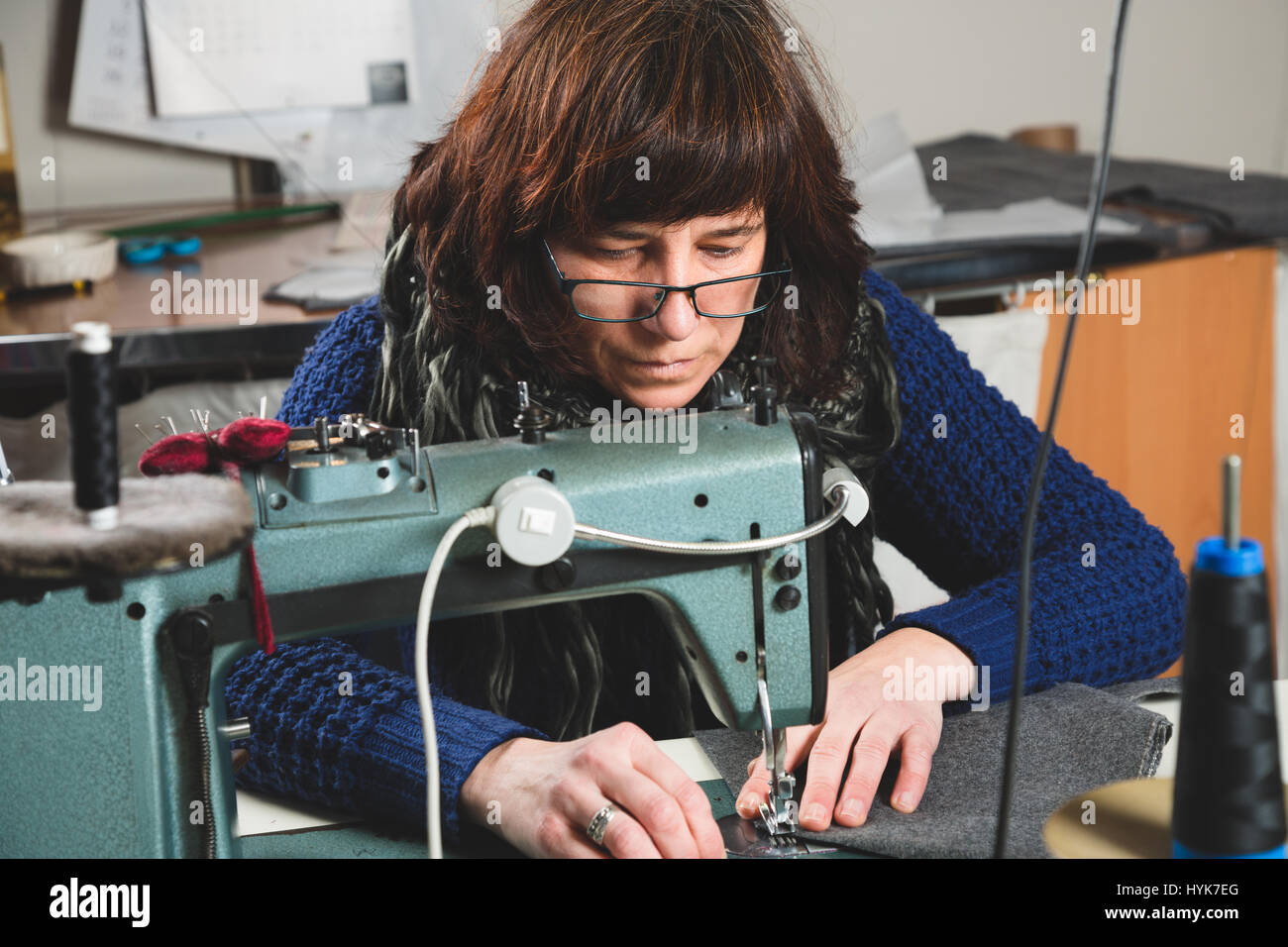 Seamstress sewing with a professional sewing machine Stock Photo Alamy