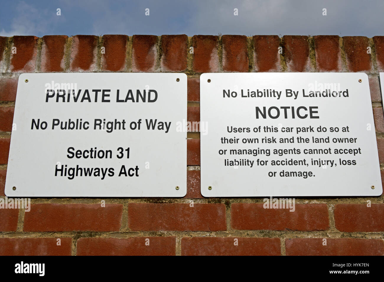 signs stating private land, no public right of way, section 31 highways act, and no liability by landlord of car park Stock Photo