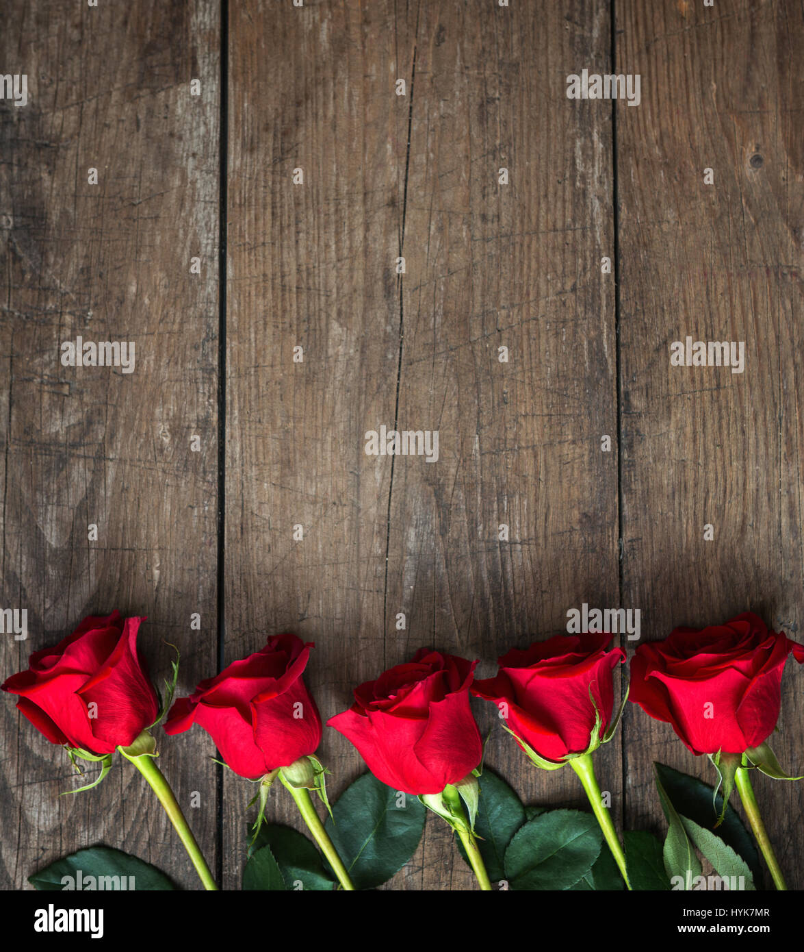Bouquet of red roses on a dark wooden background. Top view Stock Photo ...