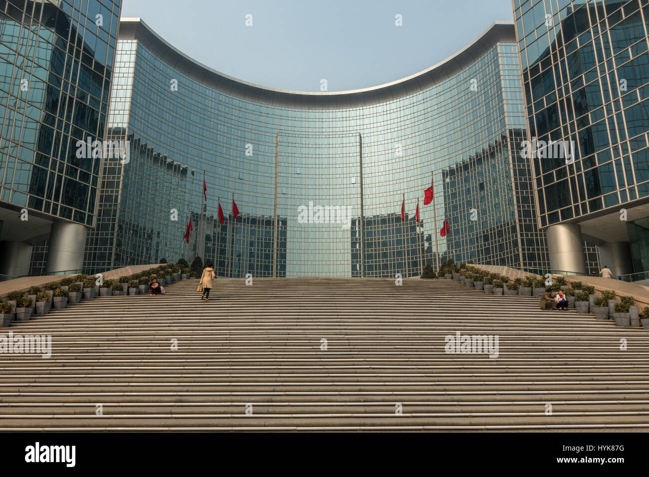 Person walking up the exterior steps of the Grand Hyatt Hotel and shopping malls at Oriental Plaza, Dongchangan Jie, central Beijing, China. Stock Photo