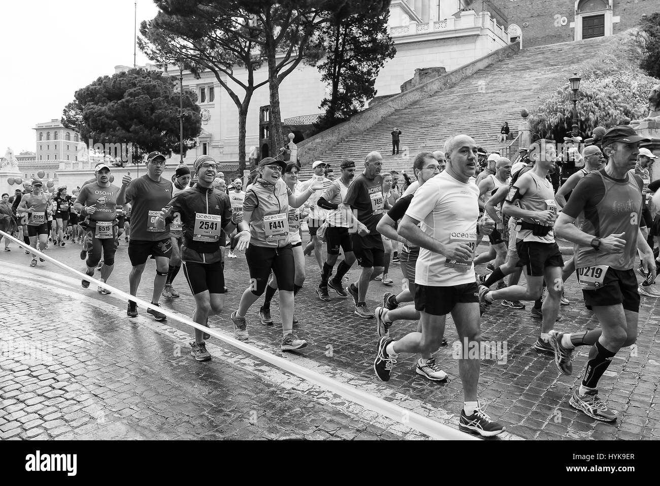 Rome, Italy - April 2, 2017: Athletes participating at the 23rd Rome marathon run through the street circuit passing the Capitol, seat of the Municipa Stock Photo