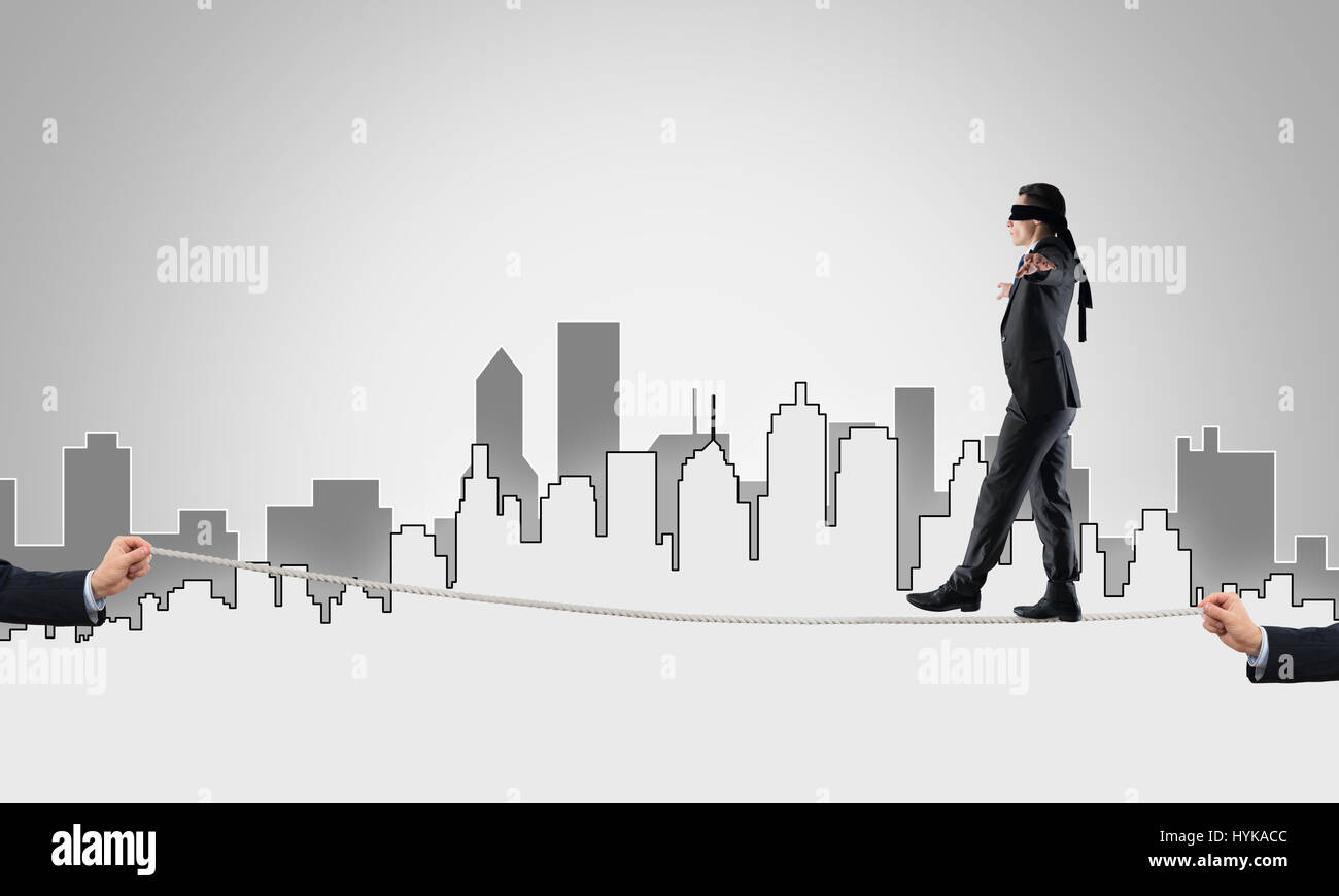 Business concept of risk support and assistance with man balancing on ...