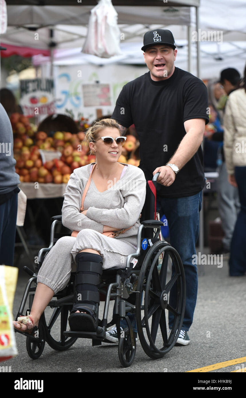 Jodie Sweetin, with a broken leg, is pushed in her wheelchair by her