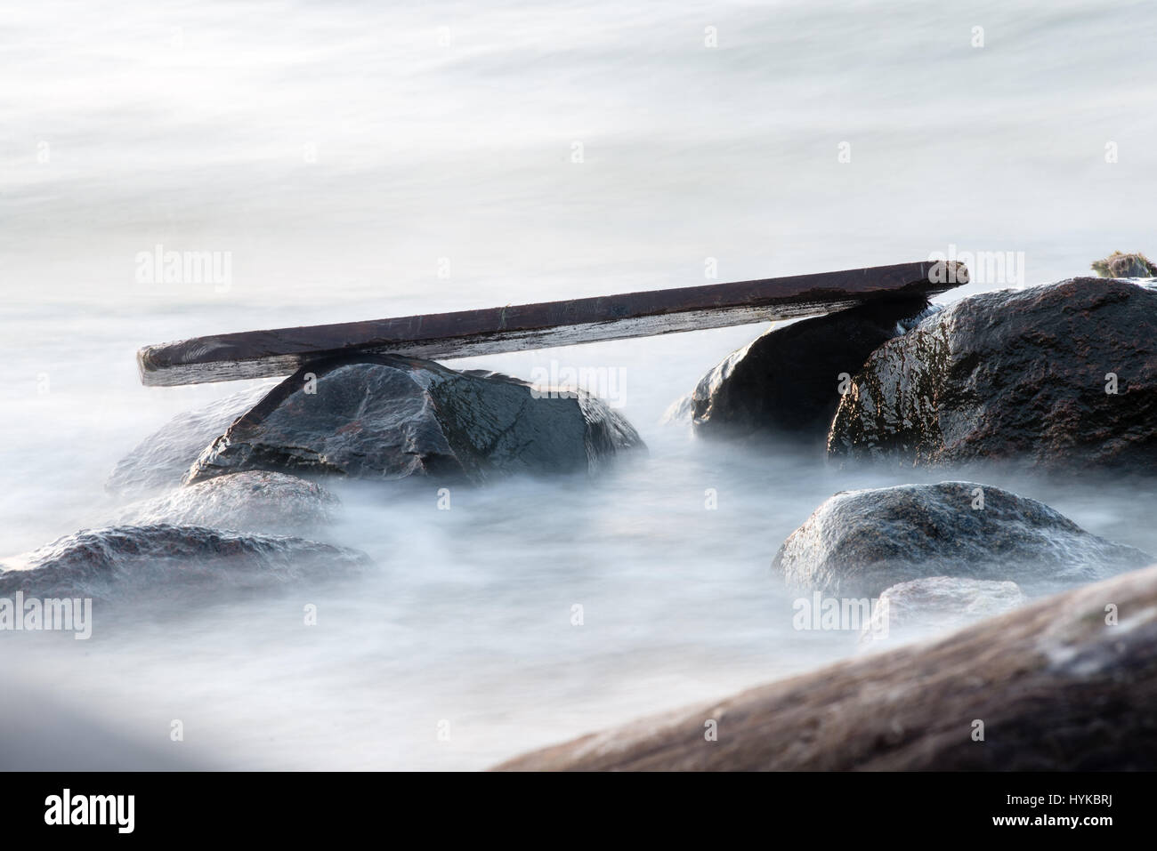 Rocky beach with clouds and water. long exposure Stock Photo - Alamy