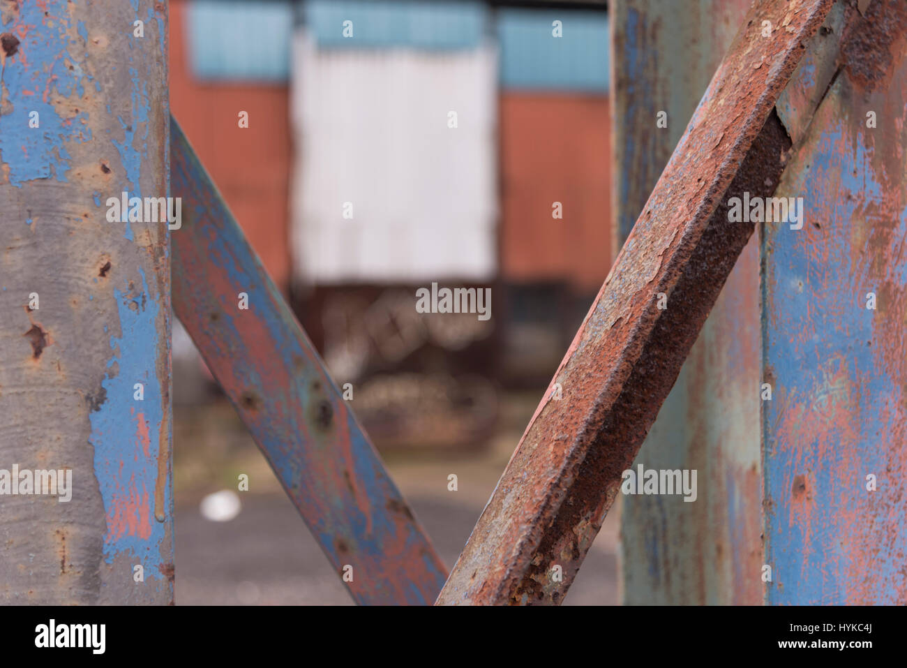 Rust settling on some steel pillars, paint is peeling from the steel