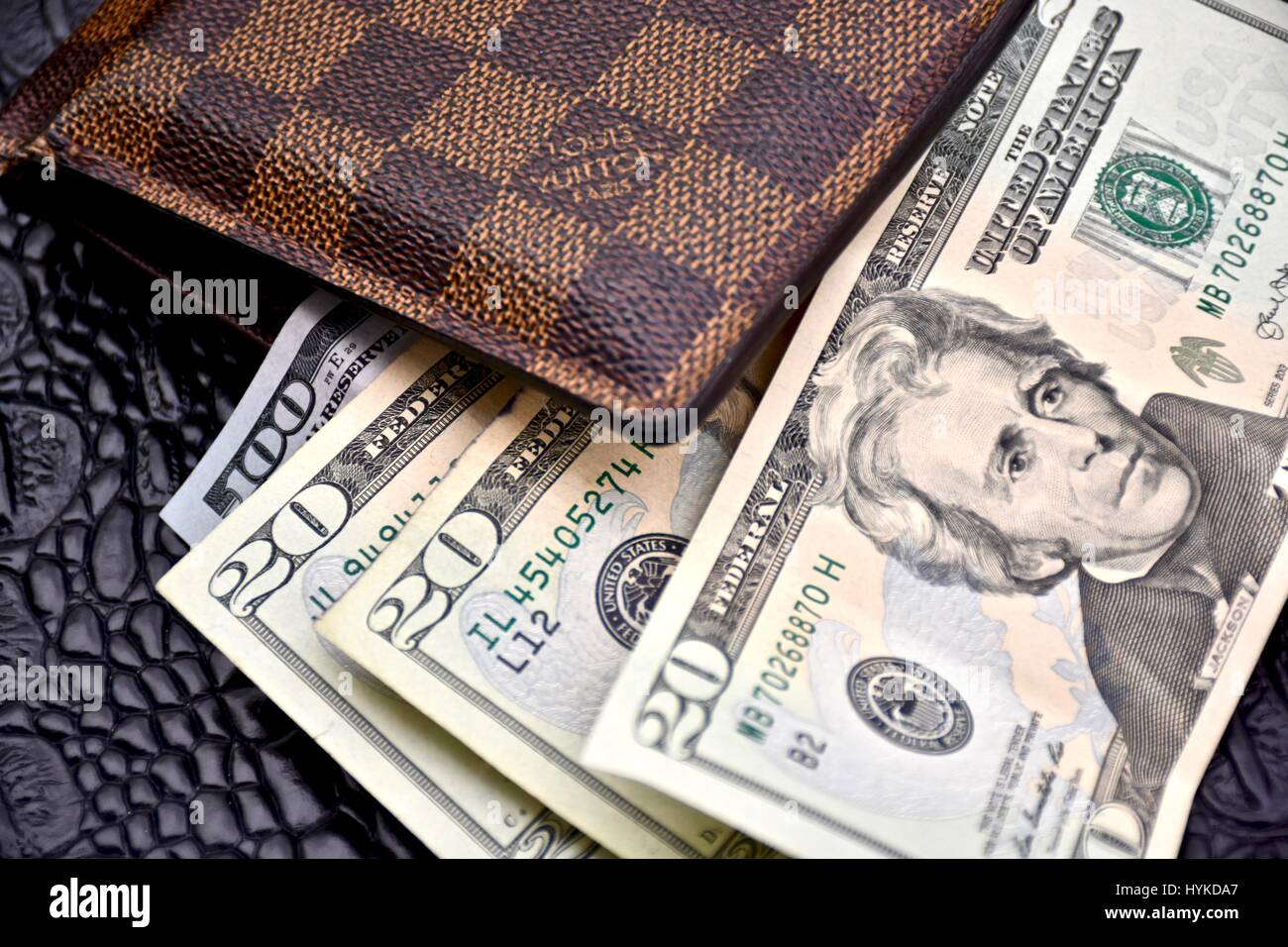 Louis Vuitton wallet filled with cash Stock Photo - Alamy