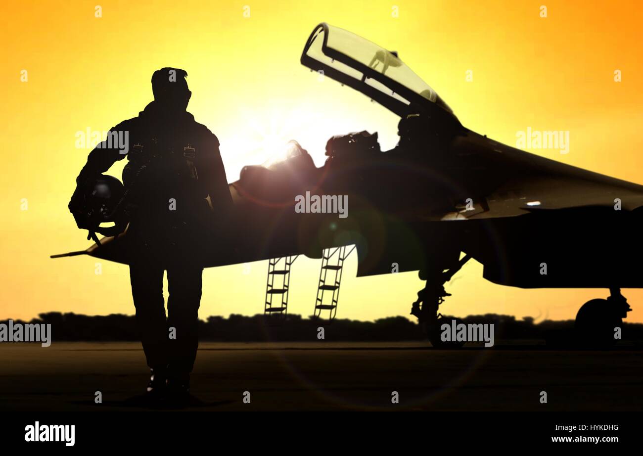 Military pilot on airfield walking away from the fighter jet Stock