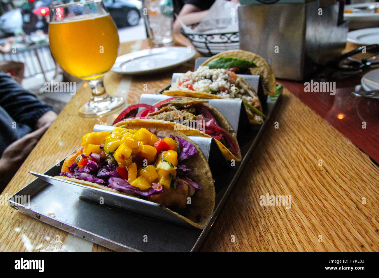 Delightful gourmet tacos ready to eat with a handcrafted beer beverage
