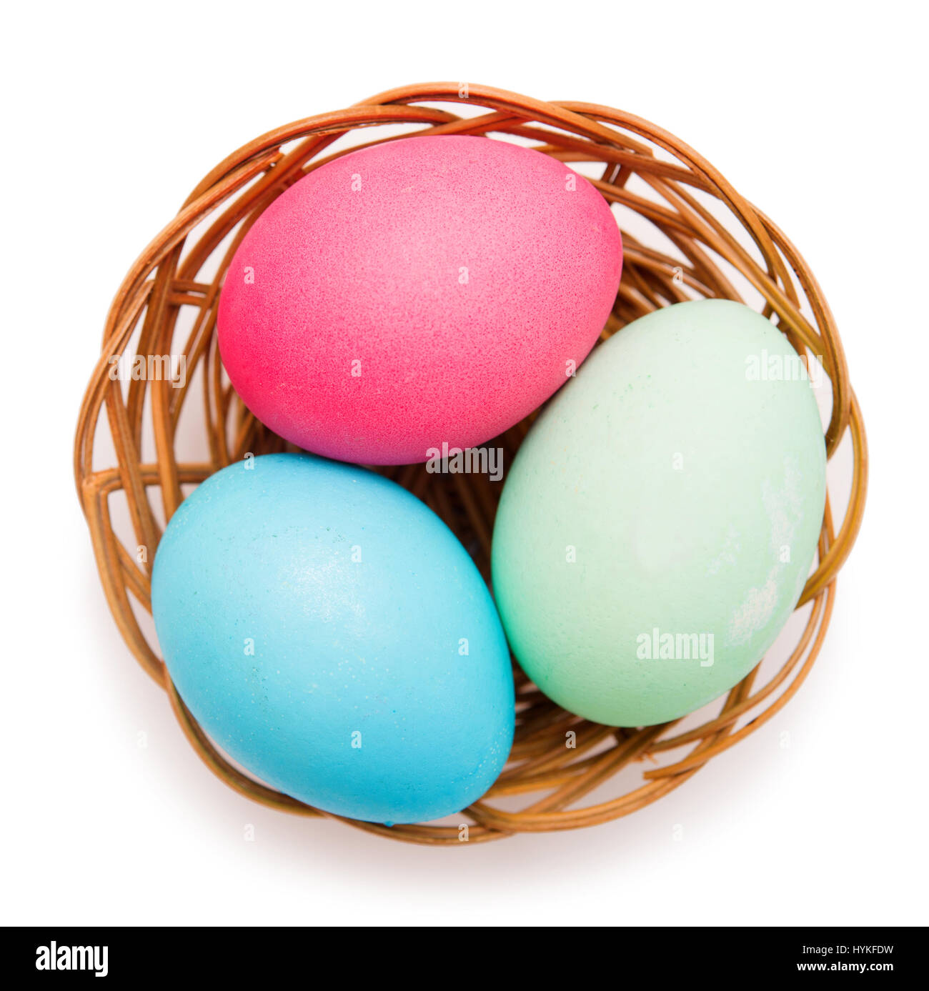 Easter eggs in a wicker basket on a white background Stock Photo - Alamy