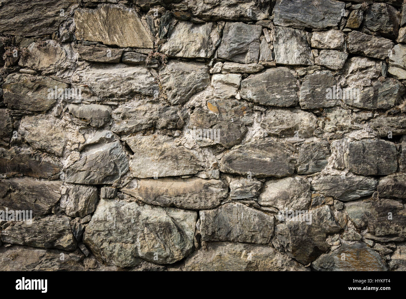 Masoned rock wall of natural stones with nice vignetting Stock Photo