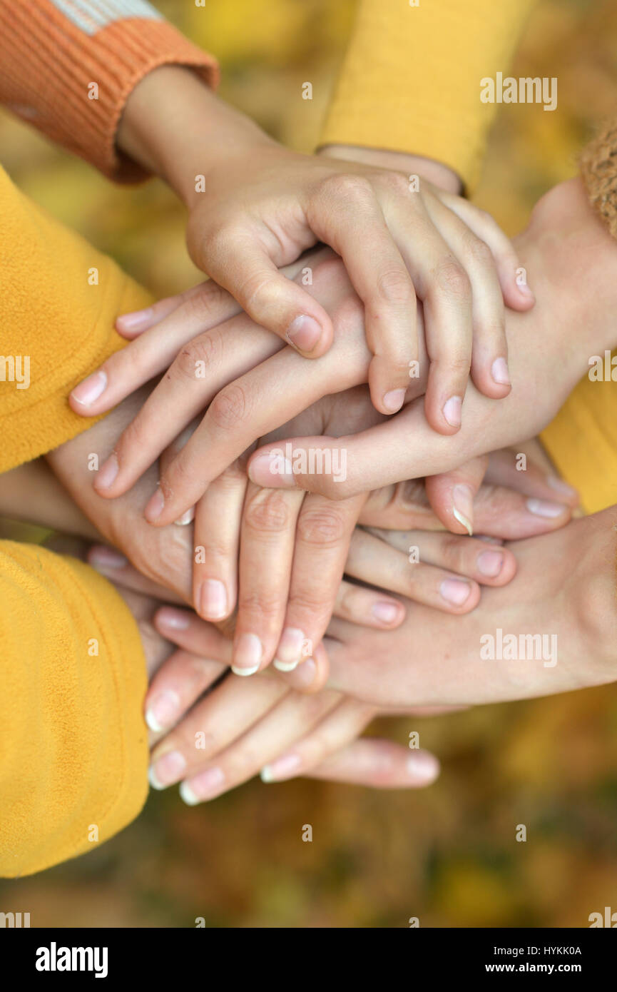 United hands on autumn background Stock Photo