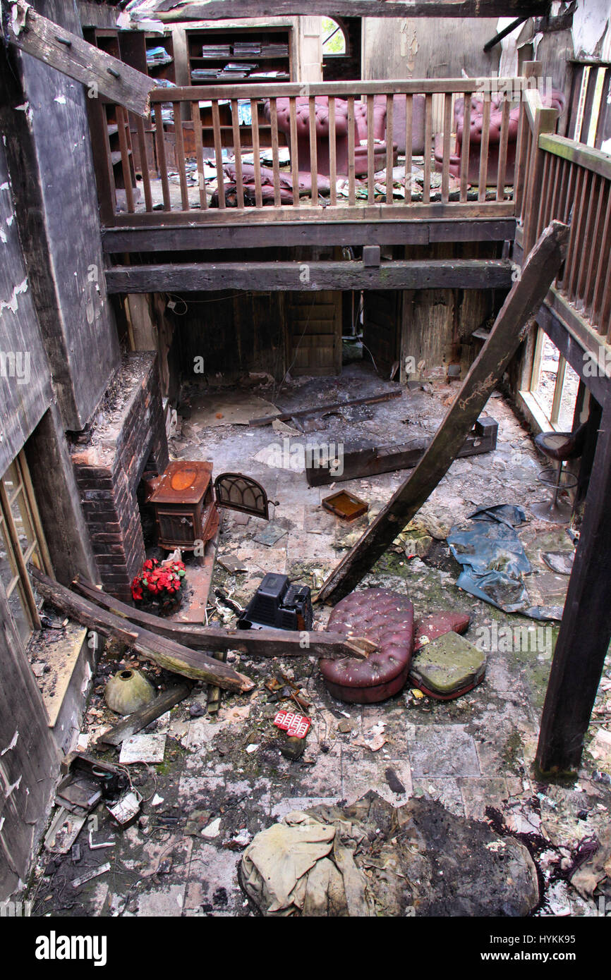 SHROPSHIRE, UK: Living room with wood burner. THE DELAPADATED remains ...