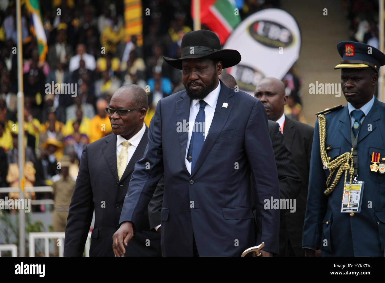 KAMPALA, UGANDA: South Sudan President Salva Kiir arrives wearing a black hat. Yoweri Museveni has been sworn in as president of Uganda today following elections that took place on February 18th 2016.  President Museveni can be seen taking the oath, signing the official documents, holding a ceremonial shield and inspecting the guard of honour. Other pictures show enthusiastic dancers, members of the police force as well as the armed forces band. The ceremony which took place during in Kampala, was the sixth time Museveni has been sworn in as president, having been in power for over thirty year Stock Photo
