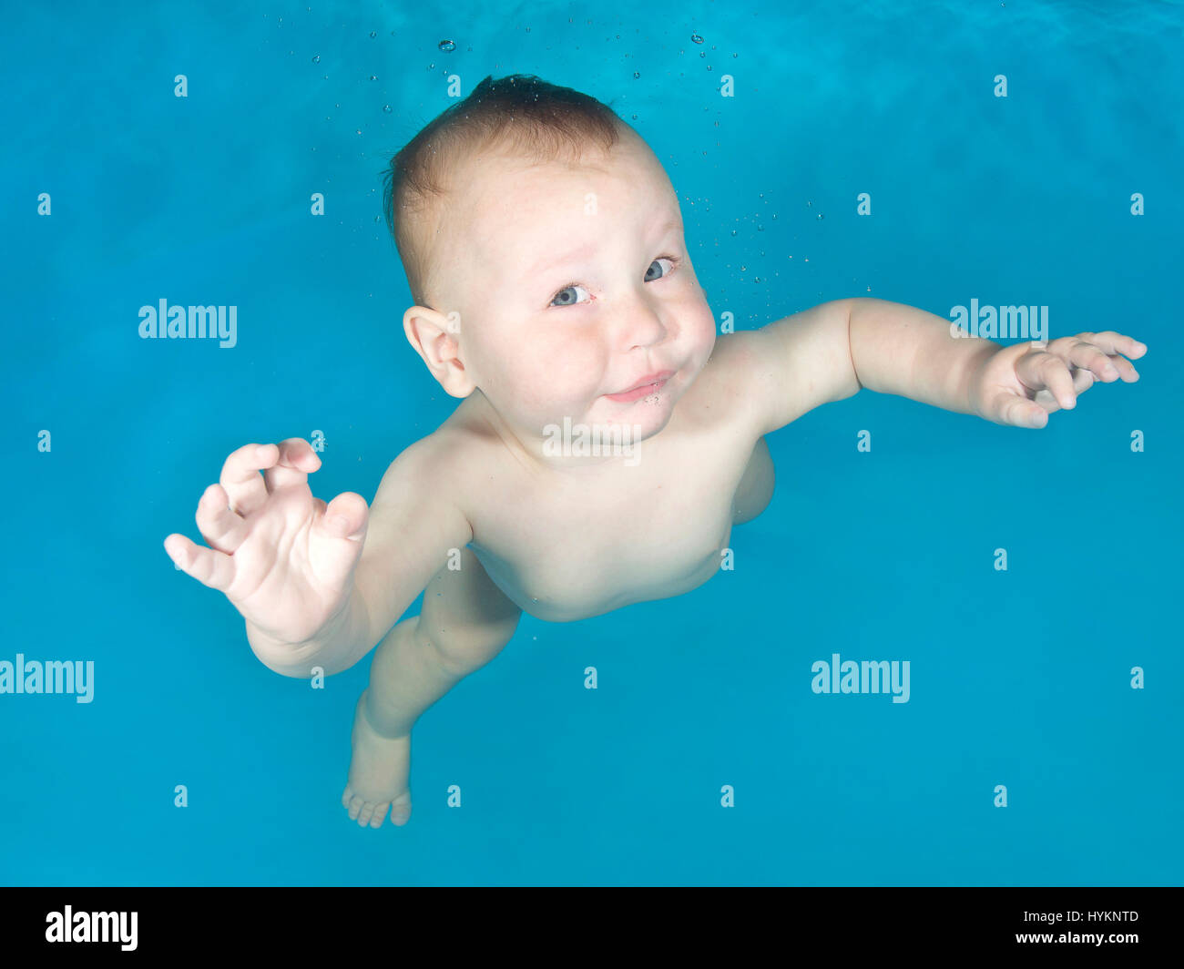 A picture of Jacob, 1 year old, at an underwater photo shoot with Little Fishes Swim School in Hertfordshire. SWIMMING before they can walk these little bathing beauties have been photographed underwater by a British photographer. Utilising their natural amphibious reflex, these babies, aged from just three months old, held their breath as they were released underwater by professional baby swim instructors.  Photographs show the hilarious expressions on the faces of the little nippers. London based underwater photographer Lucy Ray (35) from Starfish Underwater Photography took these pictures a Stock Photo
