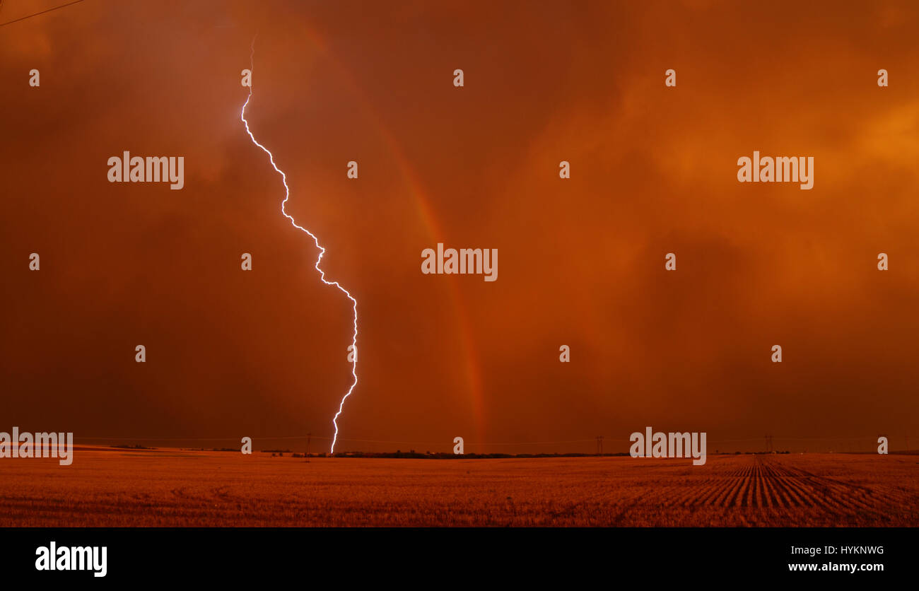 TORNADO ALLEY, USA: Lightning strike next to rainbow. THE DEADLIEST weather events have been captured on camera by one lightning quick photographer. Incredible photographs show extreme weather from America’s Tornado Alley, renowned for the frequency of its storms. From terrifying lightning bolts to all-encompassing tornados, these pictures manage to capture to ferocity and atmosphere of these natural phenomena. Stock Photo