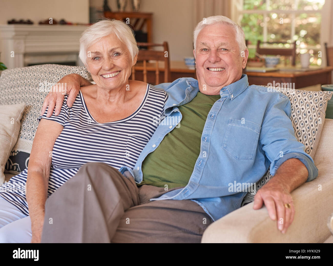 Couple of relaxed seniors sitting on their couch Stock Photo Alamy