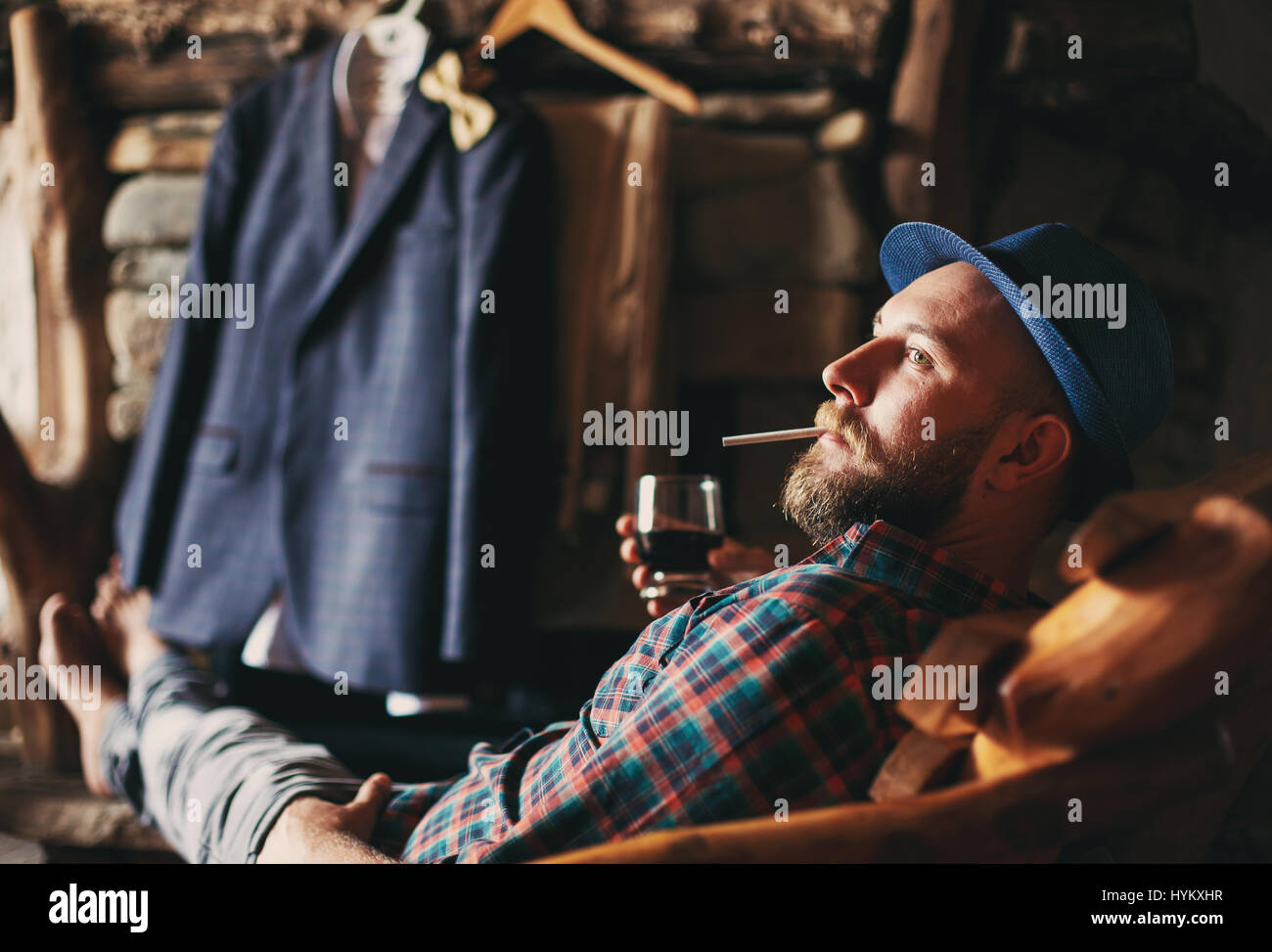 man drinking whiskey lying in a chair Stock Photo