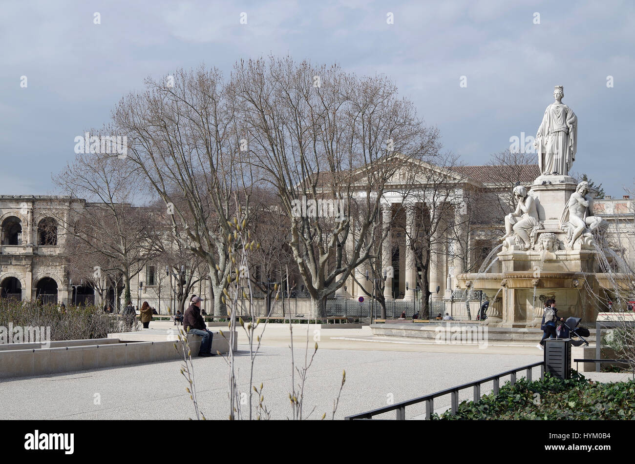 View from within the garden of the Esplanade Charles de Gaulle showing the Roman amphitheatre, the Palais de Justice and the Pradier fountain Stock Photo