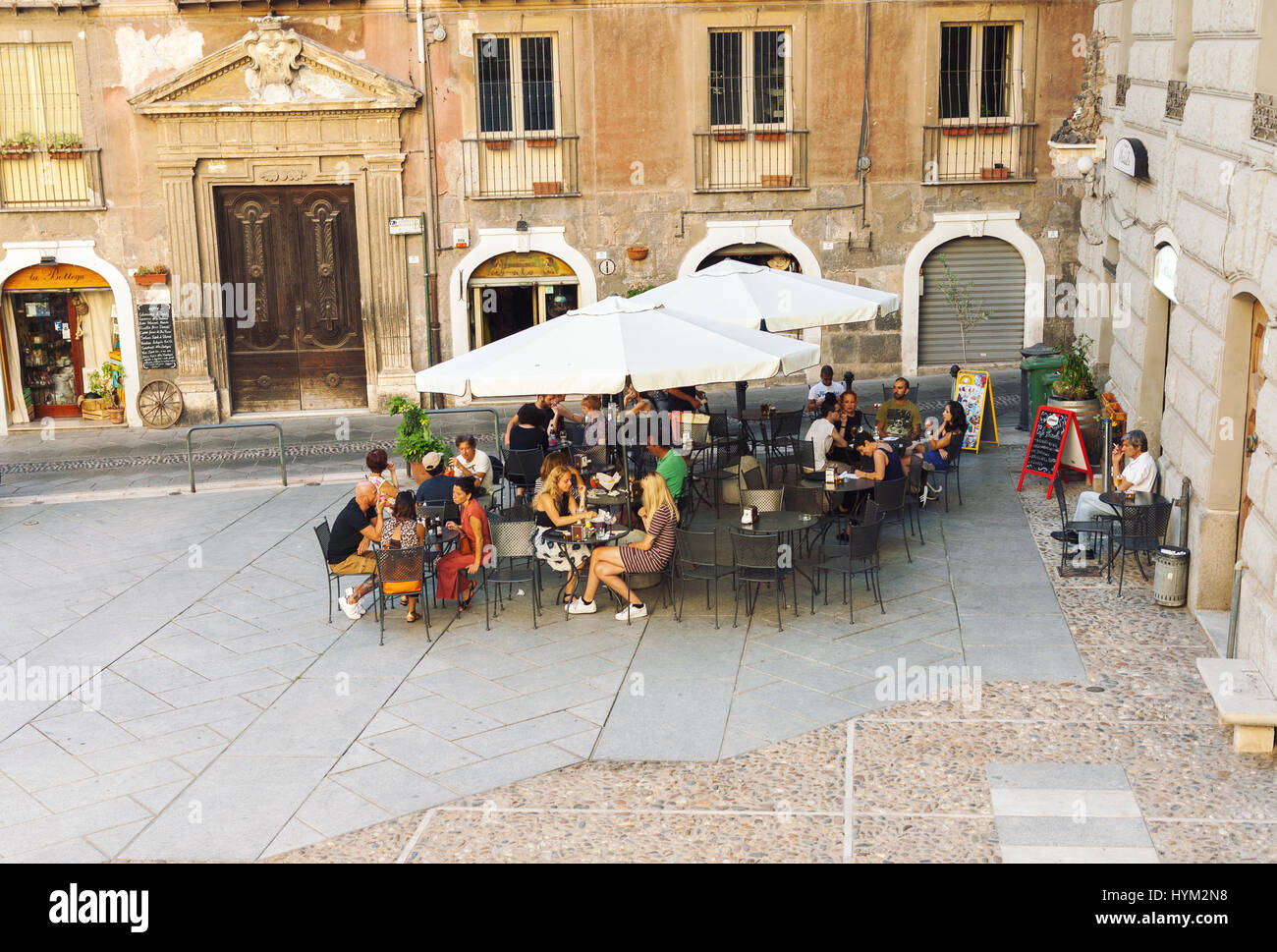 CAGLIARI, ITALY - JULY 07, 2016: People eating at outdoor cafe located in traditional small city square in Cagliari, Italy Stock Photo