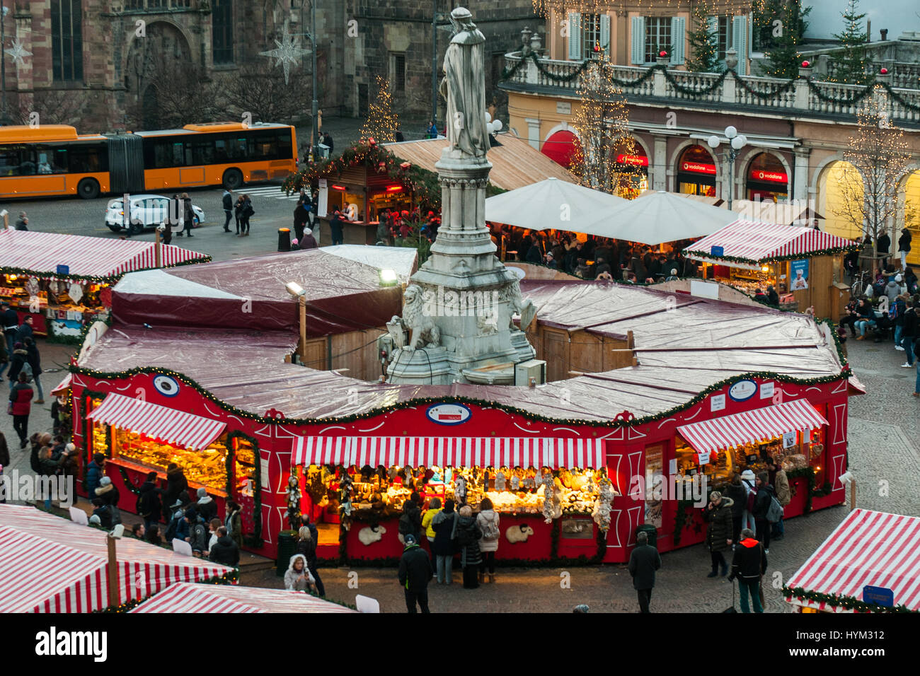 A view of the statue with the traditional Christmas markets of Bolzano, in Italy. Stock Photo