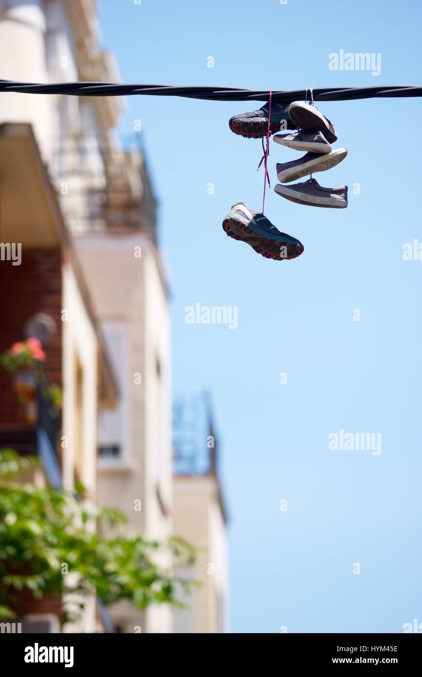 Shoes hanging from electric wire hi-res stock photography and images - Alamy