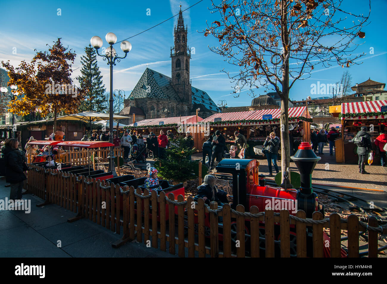Children play in a small train at the traditional Christmas markets of Bolzano, in Italy. Stock Photo