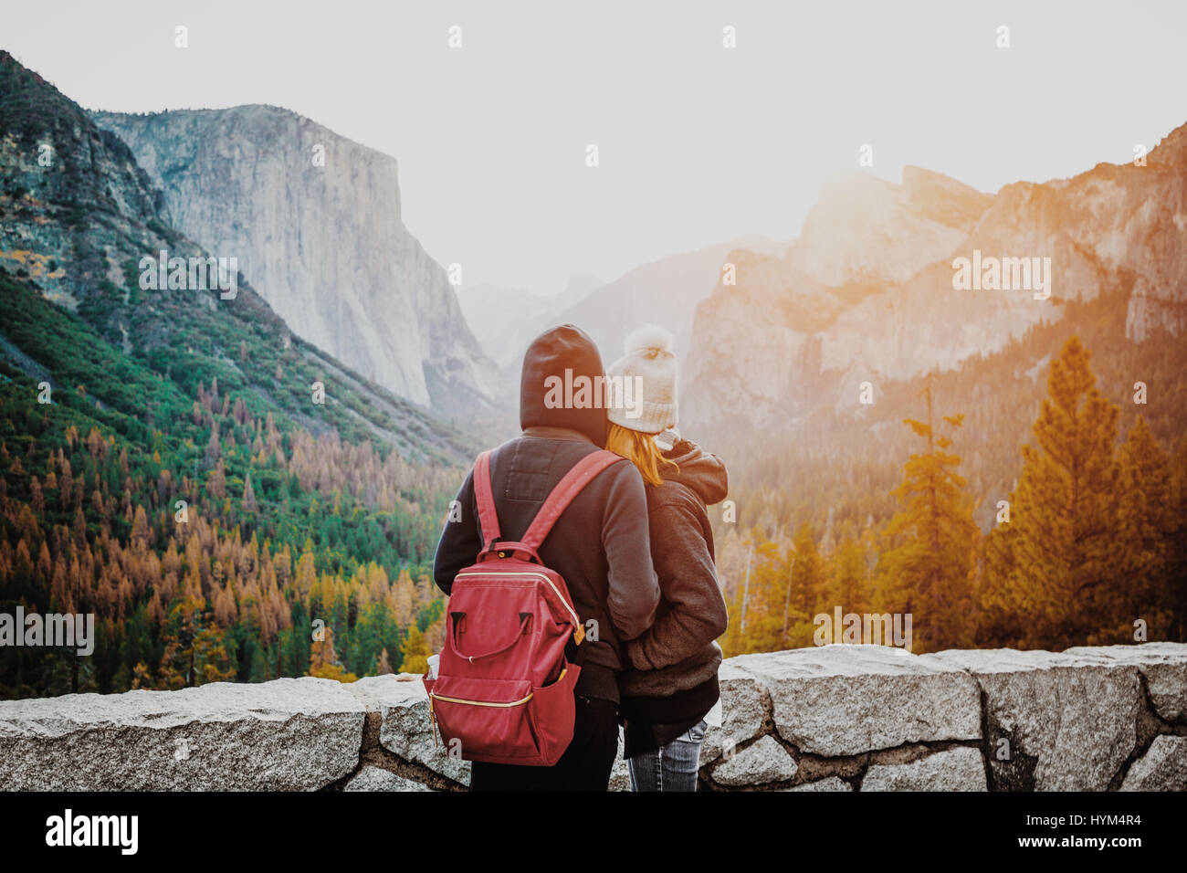 Romantic view of a young couple enjoying famous Tunnel View in beautiful golden morning light at sunrise in Yosemite Valley in summer with retro vinta Stock Photo