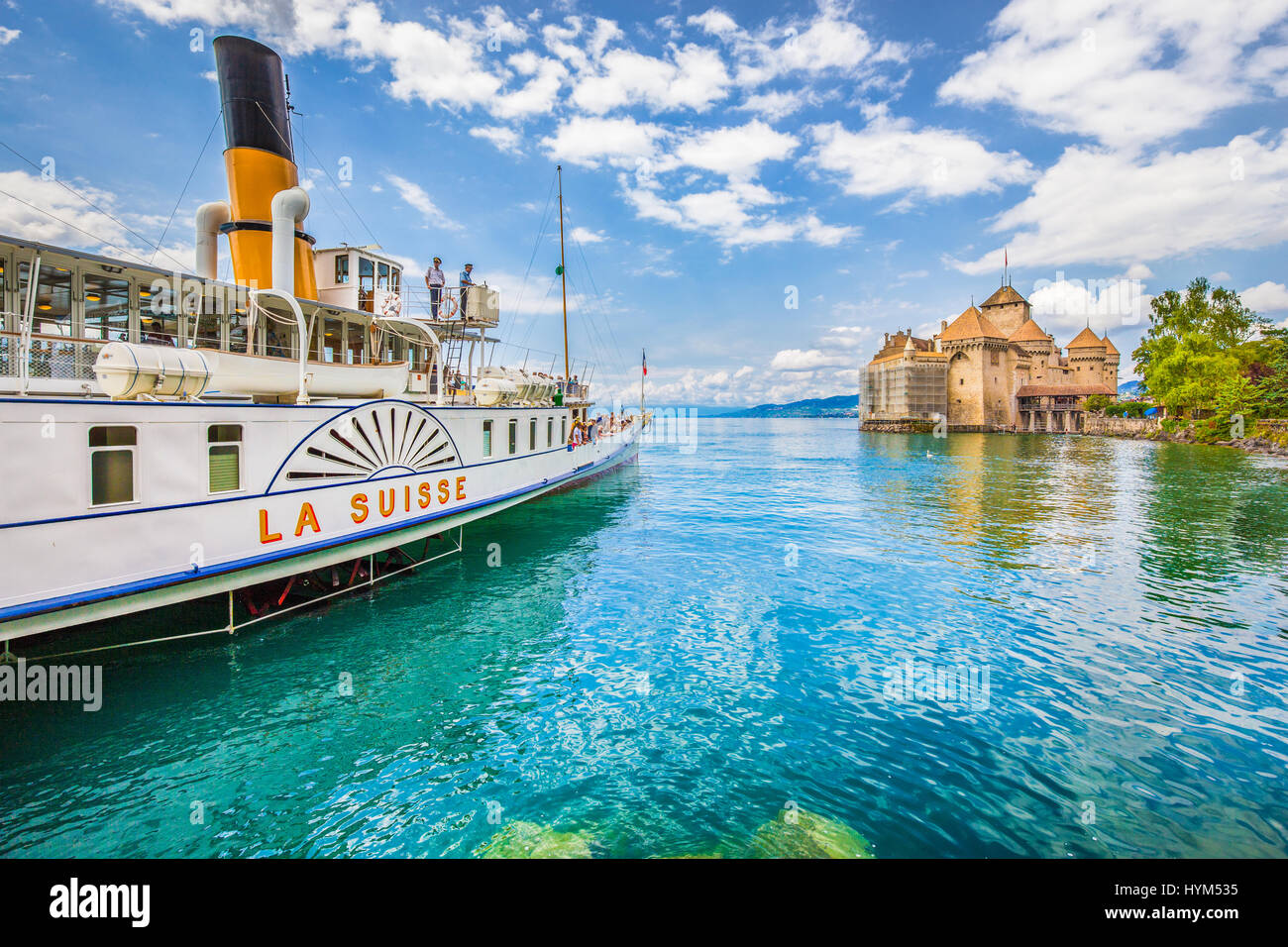 Beautiful view of traditional paddle steamer excursion ship with famous Chateau de Chillon at Lake Geneva in summer, Canton of Vaud, Switzerland Stock Photo