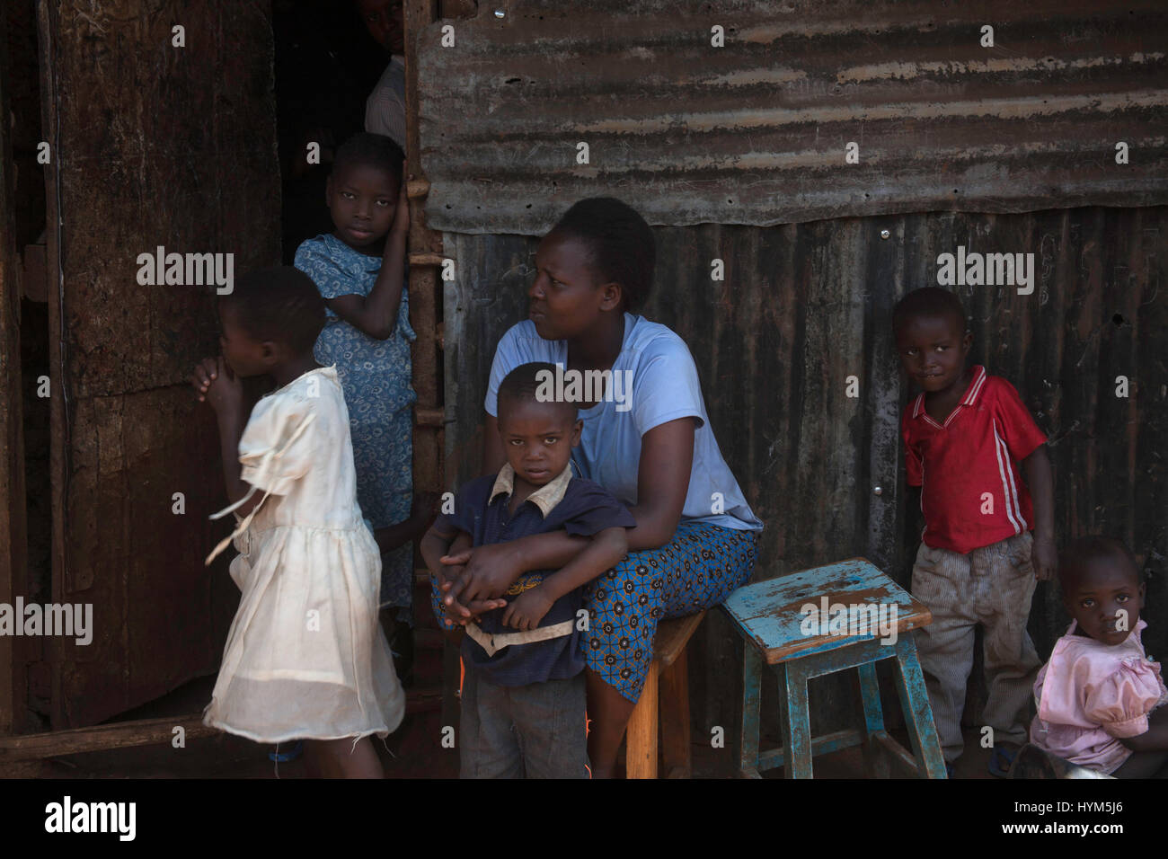 People sitting in the street in Kibera slums, Nairobi, Kenya, East Africa Stock Photo