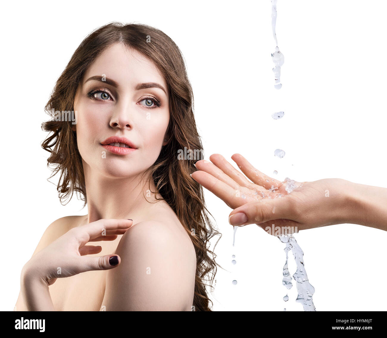 Woman face and pouring water in hand. Stock Photo