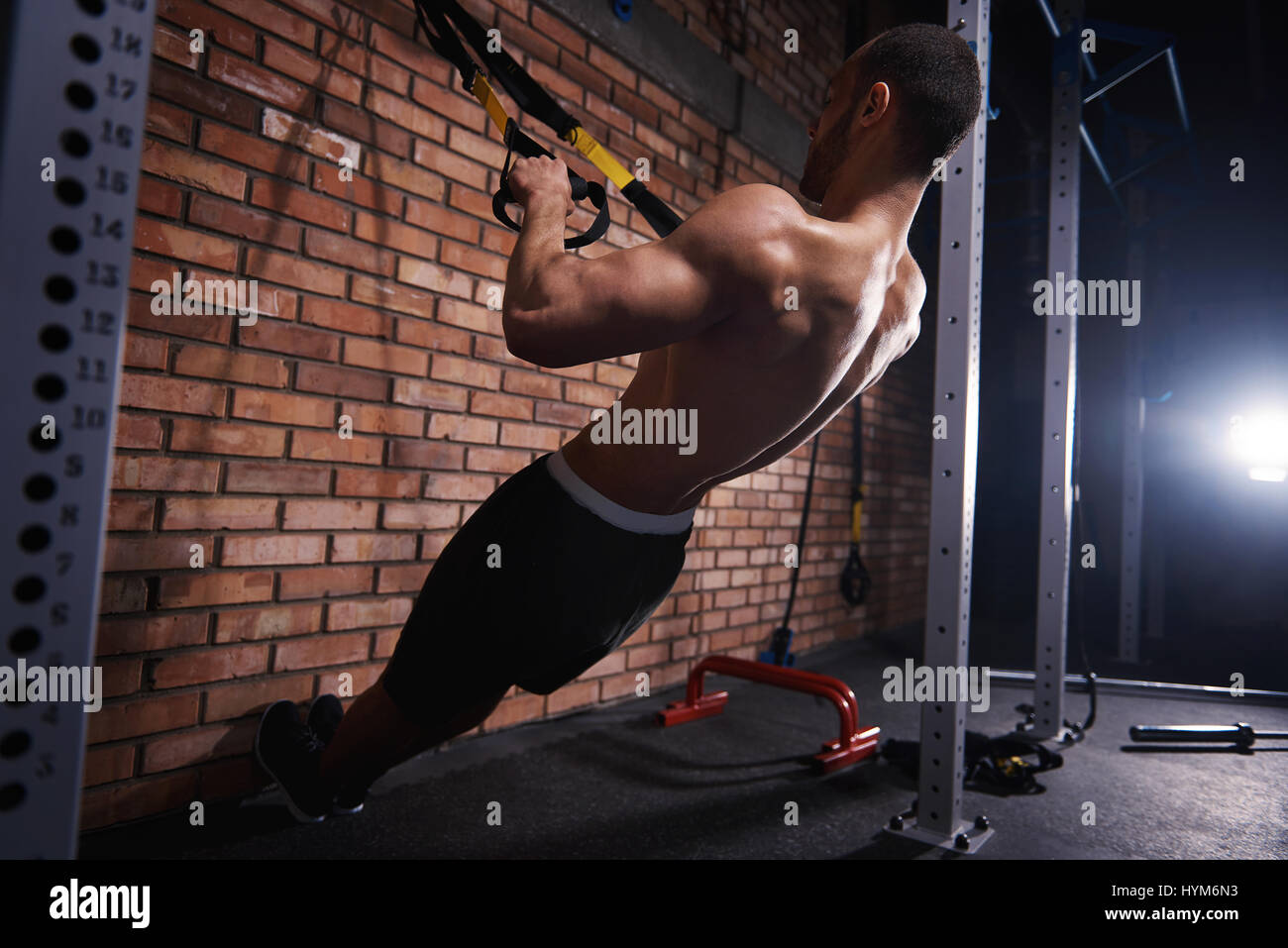 Muscular man pulling resistance bands Stock Photo - Alamy