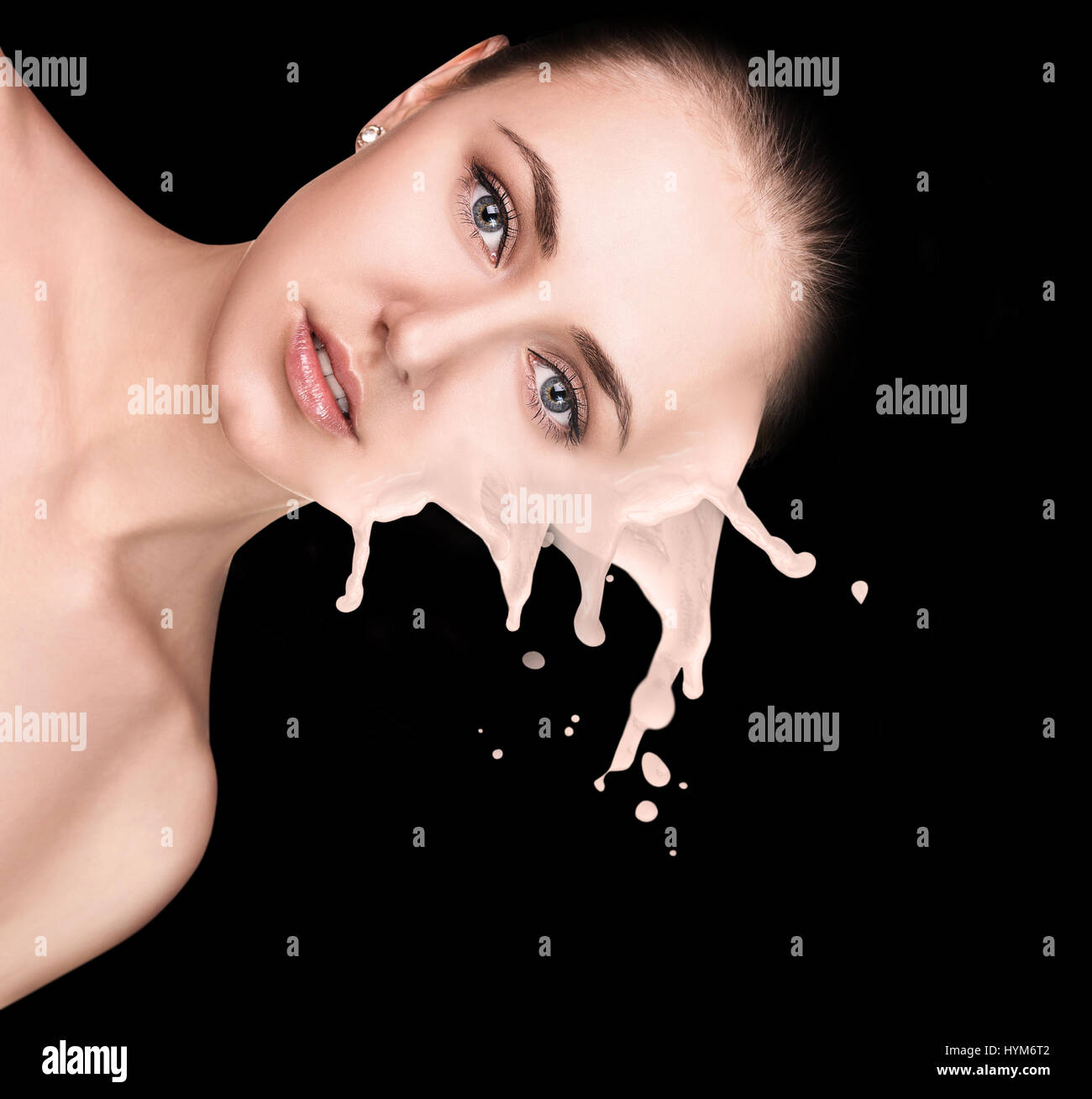 Young woman with beige foundation splashes. Stock Photo